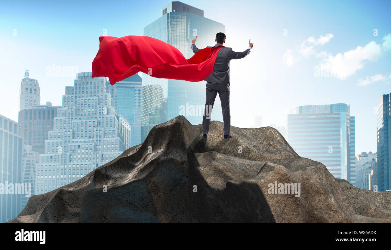 Superhero businessman on top of mountain Stock Photo - Alamy