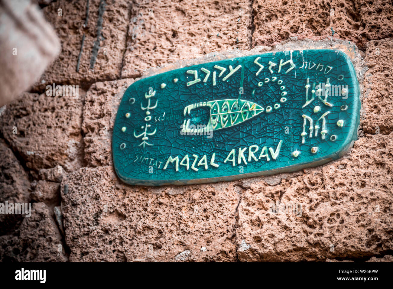 Street sign with horoscope signs in old city of Jaffa, Israel, Mazal Akrav - Scorpius Stock Photo
