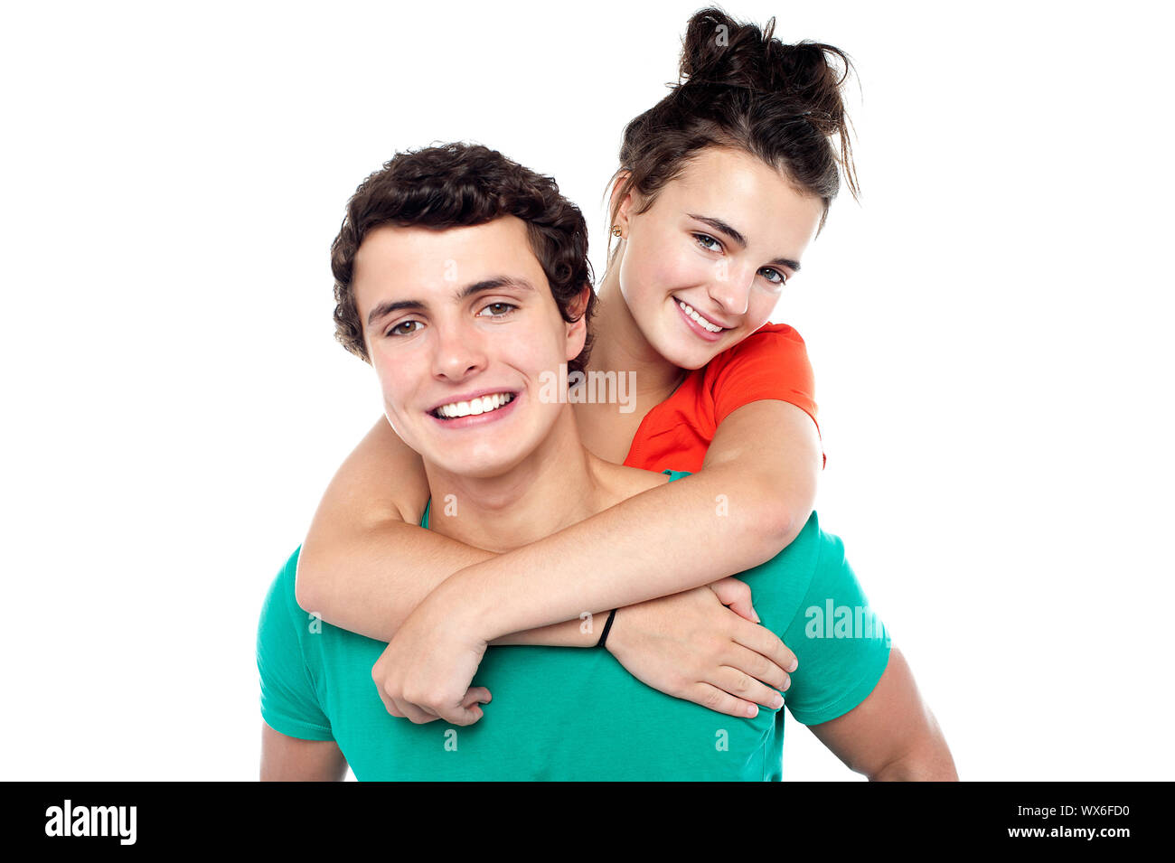 Man giving boy piggyback ride Man giving boy piggy back ride against white  background, model