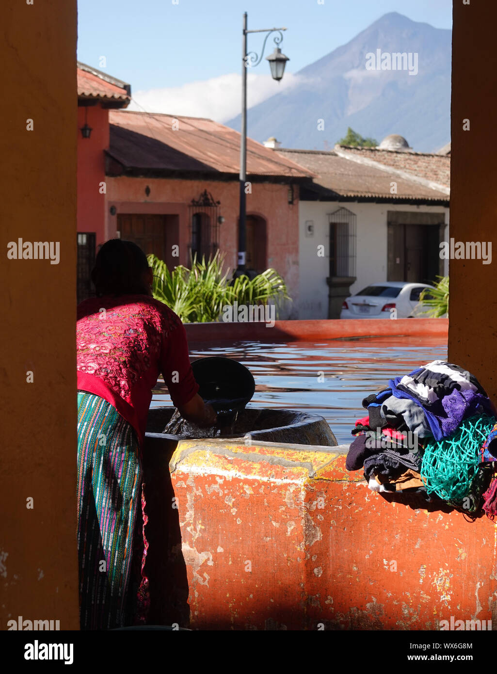 Doing laundry the ancient way and with a volcano view in Antigua, Guatemala Stock Photo