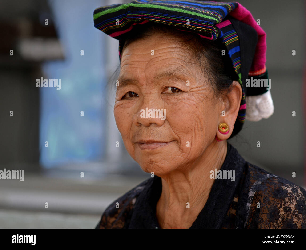 Elderly Myanmarese Palaung/Palong tribal woman with traditional earlobe plugs poses for the camera. Stock Photo