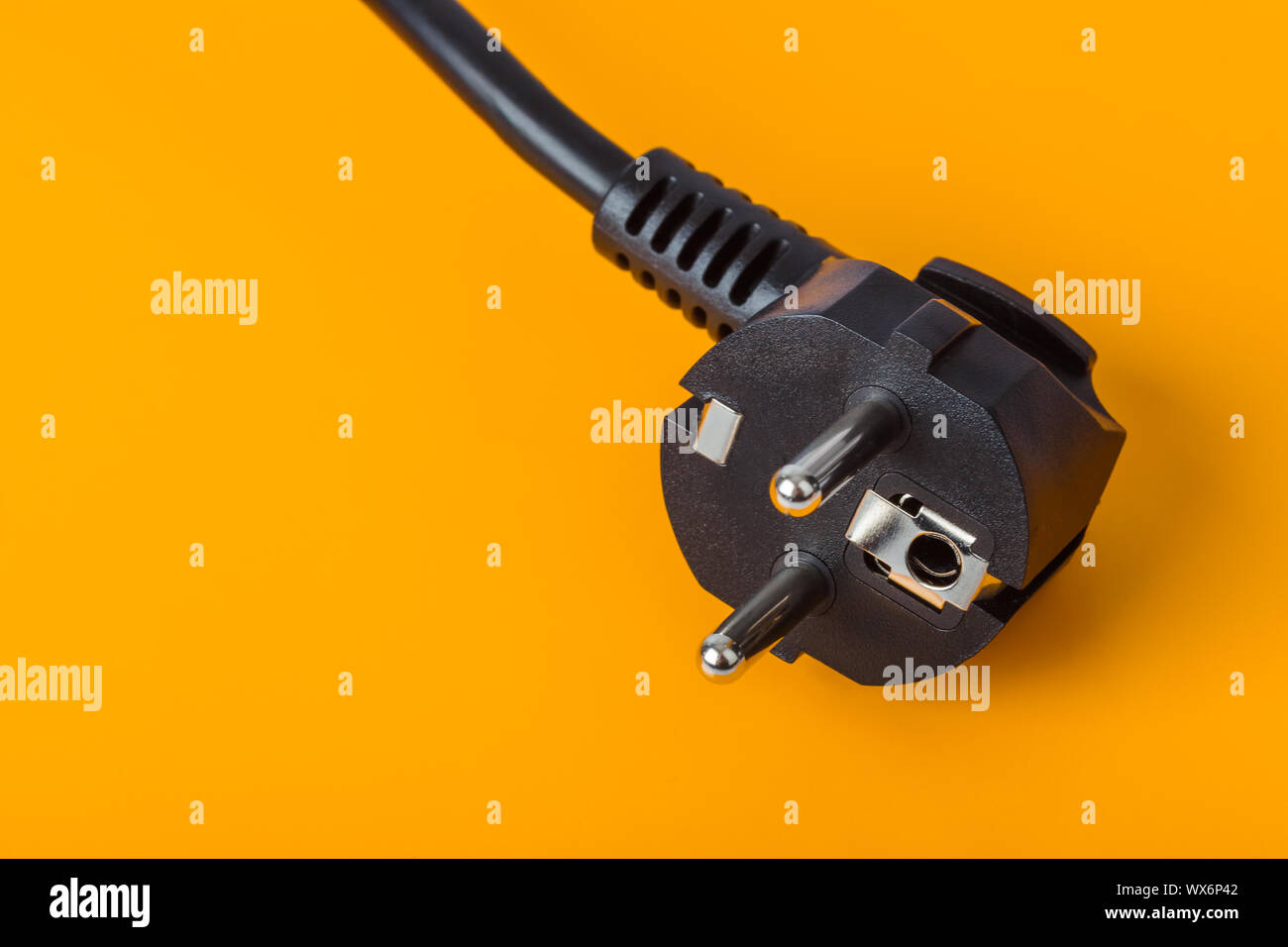 Electrical plug on orange background Stock Photo
