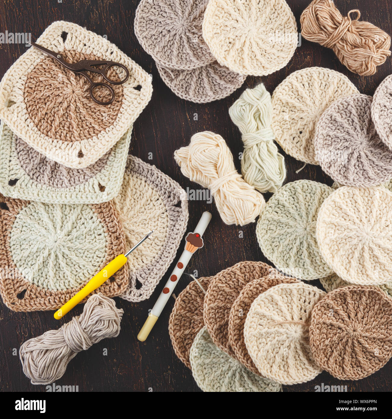 Crochet yarn, crochet hooks, and hand made granny squares. Stock Photo