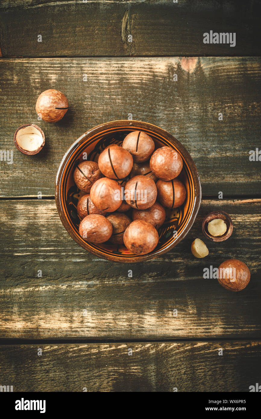 Macadamia nuts on wooden table Stock Photo