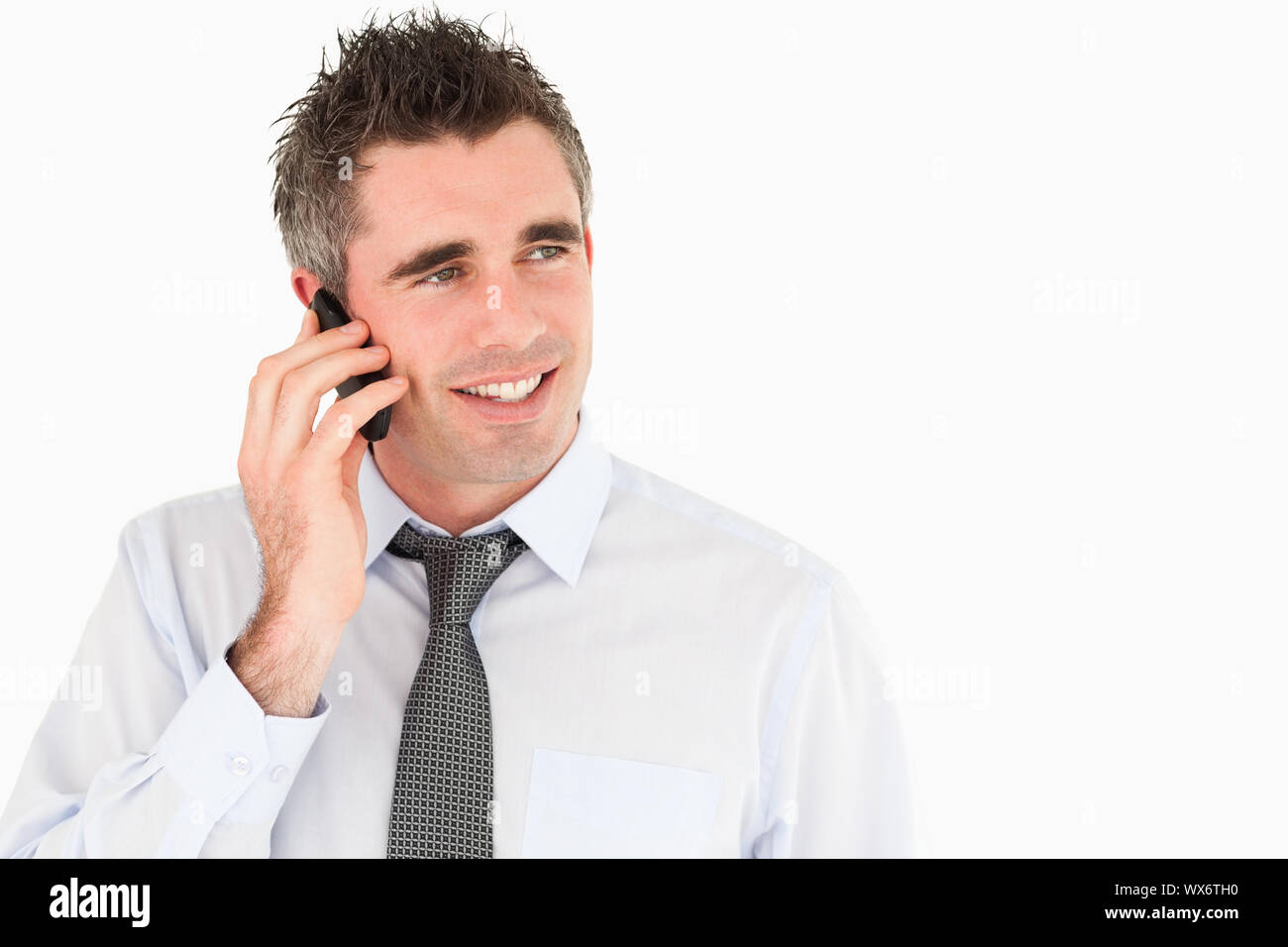 Happy man making a phone call against a white background Stock Photo ...
