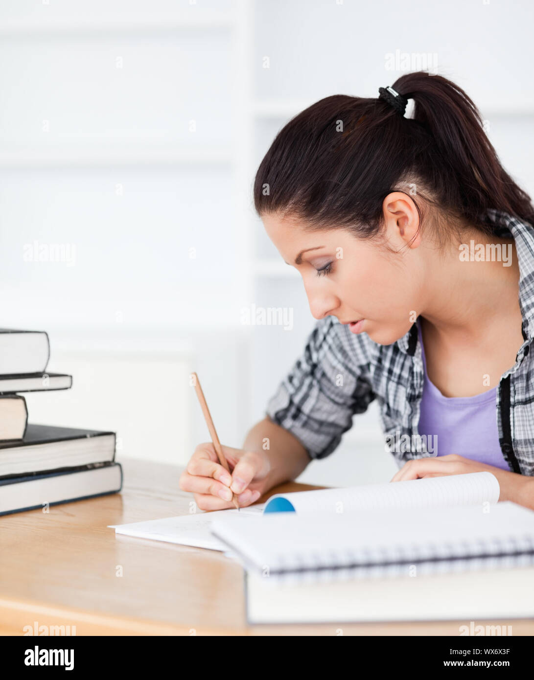 Example Student Exercise Book Writing A young student is writing in her exercise book Stock Photo - Alamy