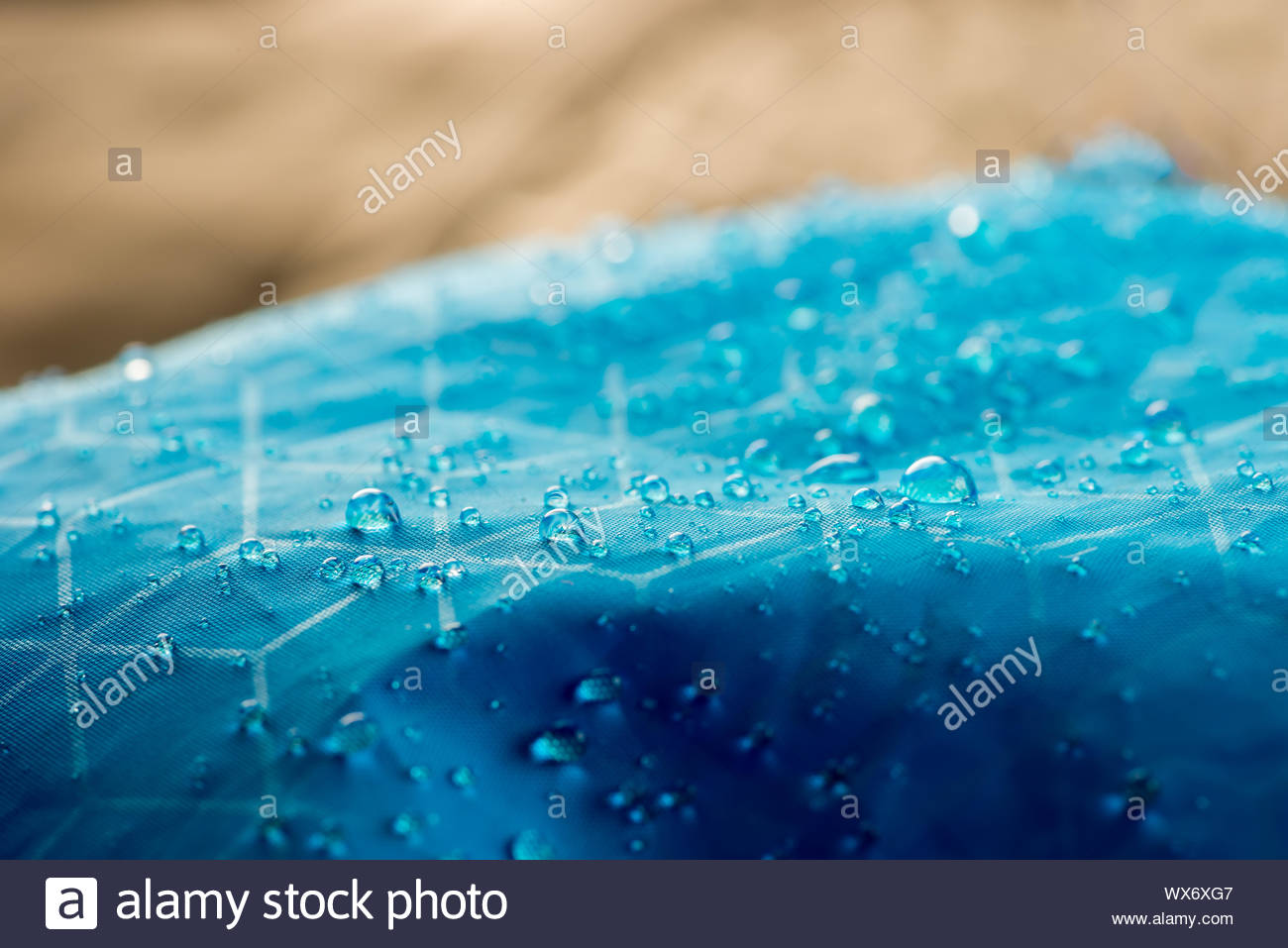 Macro water drops, detail view of droplets on a high quality waterproof blue nylon fabric Stock Photo