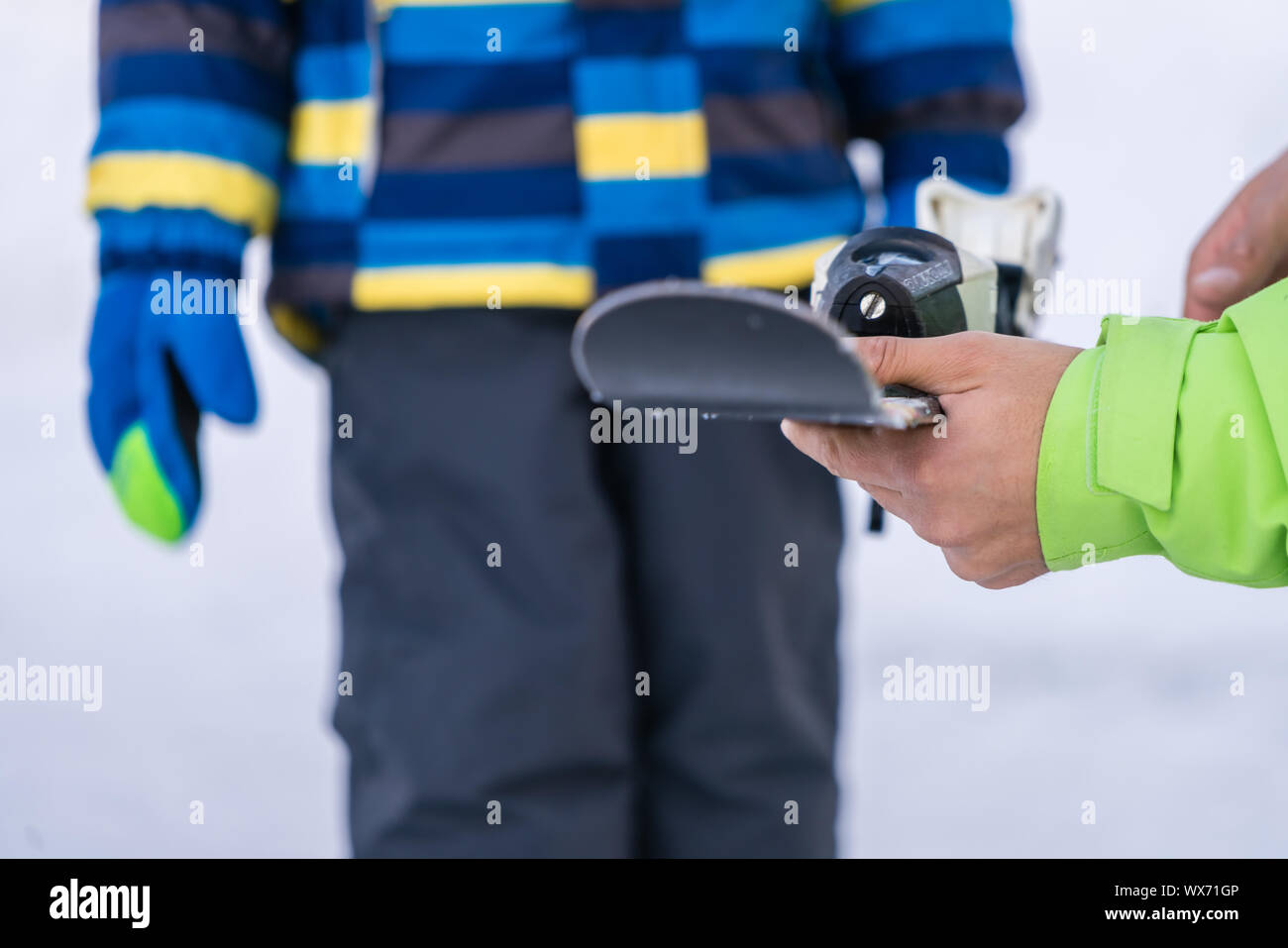 Ski instructor holding ski Stock Photo