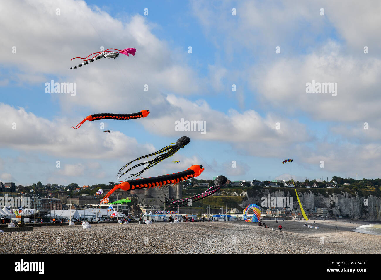 DIEPPE, FRANCE - SEPTEMBER 11, 2018: Kite festival. Octopus kites and flying caterpillar in the sky in Atlantic ocean Stock Photo
