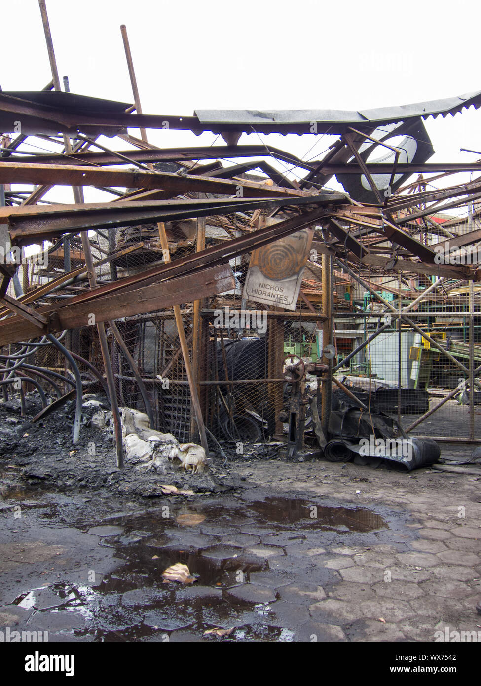 Twisted steel beams after a factory fire. Warehouse destroyed by fire