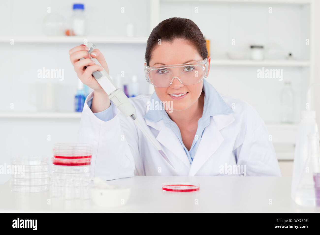 Cute scientist looking at the camera while preparing a sample Stock Photo
