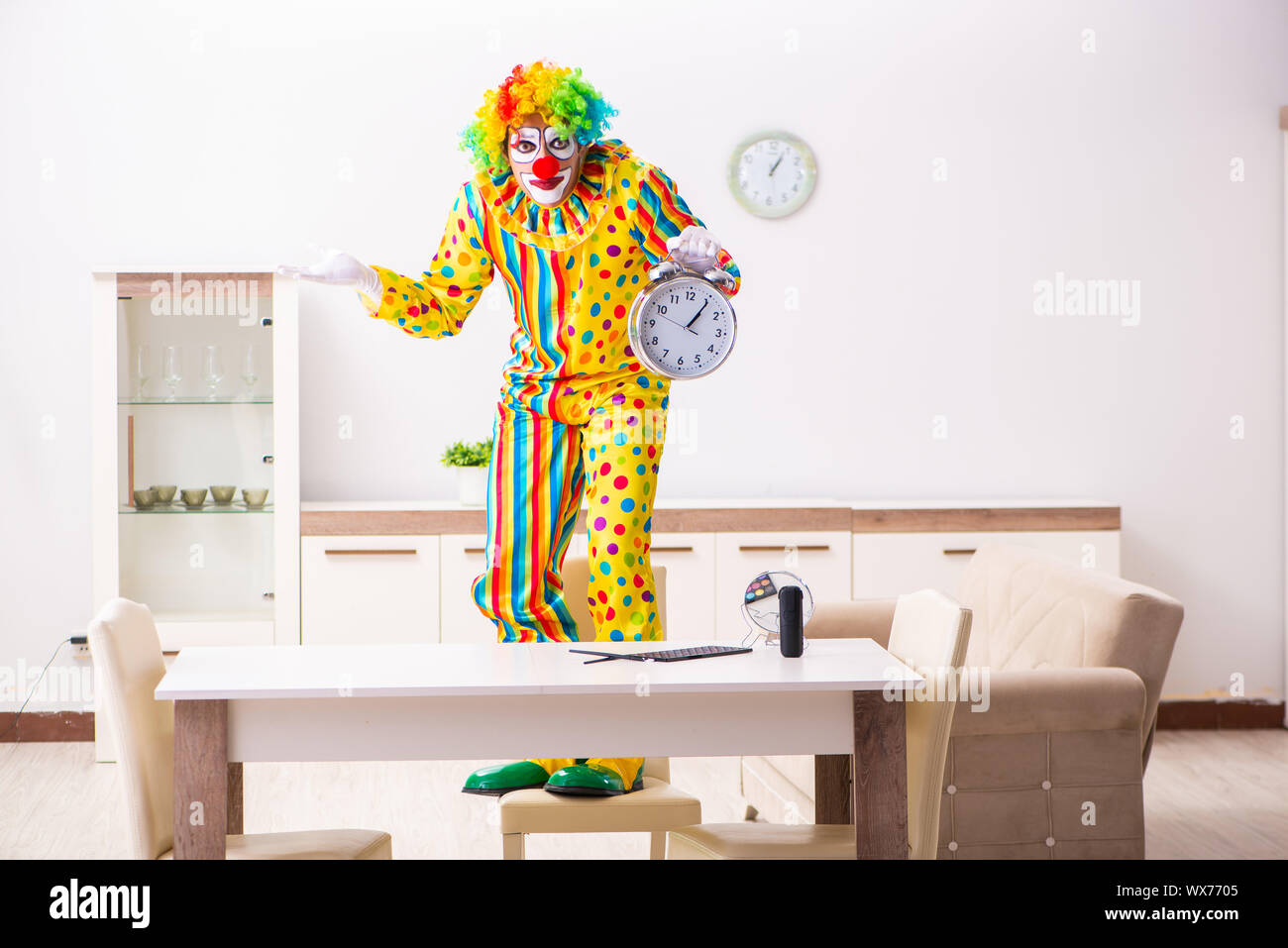 Male clown preparing for perfomance at home Stock Photo