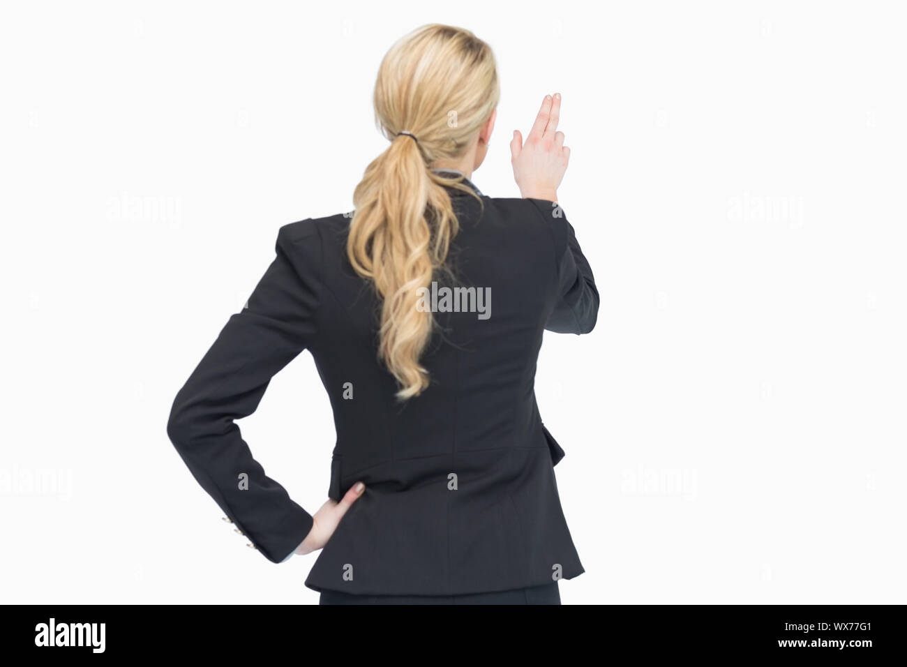 Business woman pointing out something from behind Stock Photo - Alamy