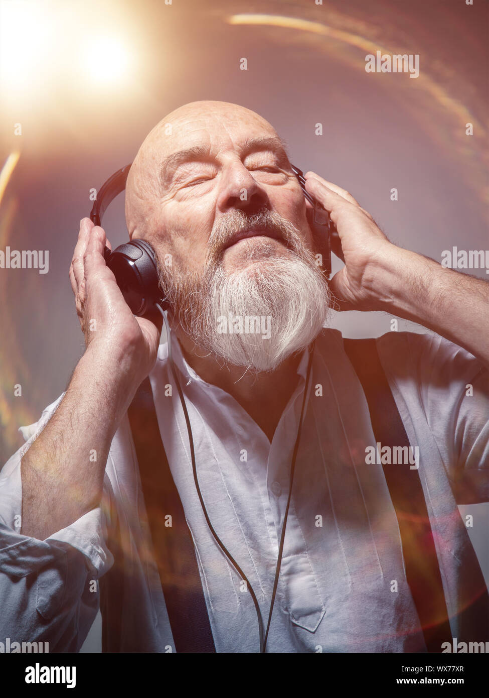 elderly bald head man with headphones Stock Photo