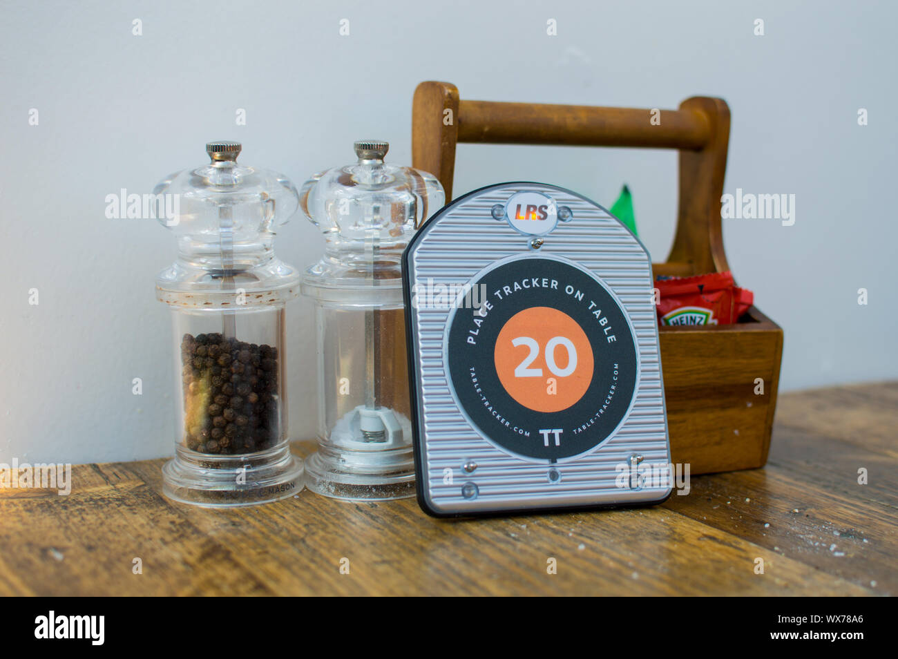 Restaurant order tracker on table next to condiments Stock Photo Alamy