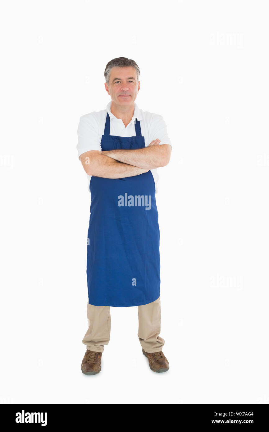 Man standing in blue apron Stock Photo
