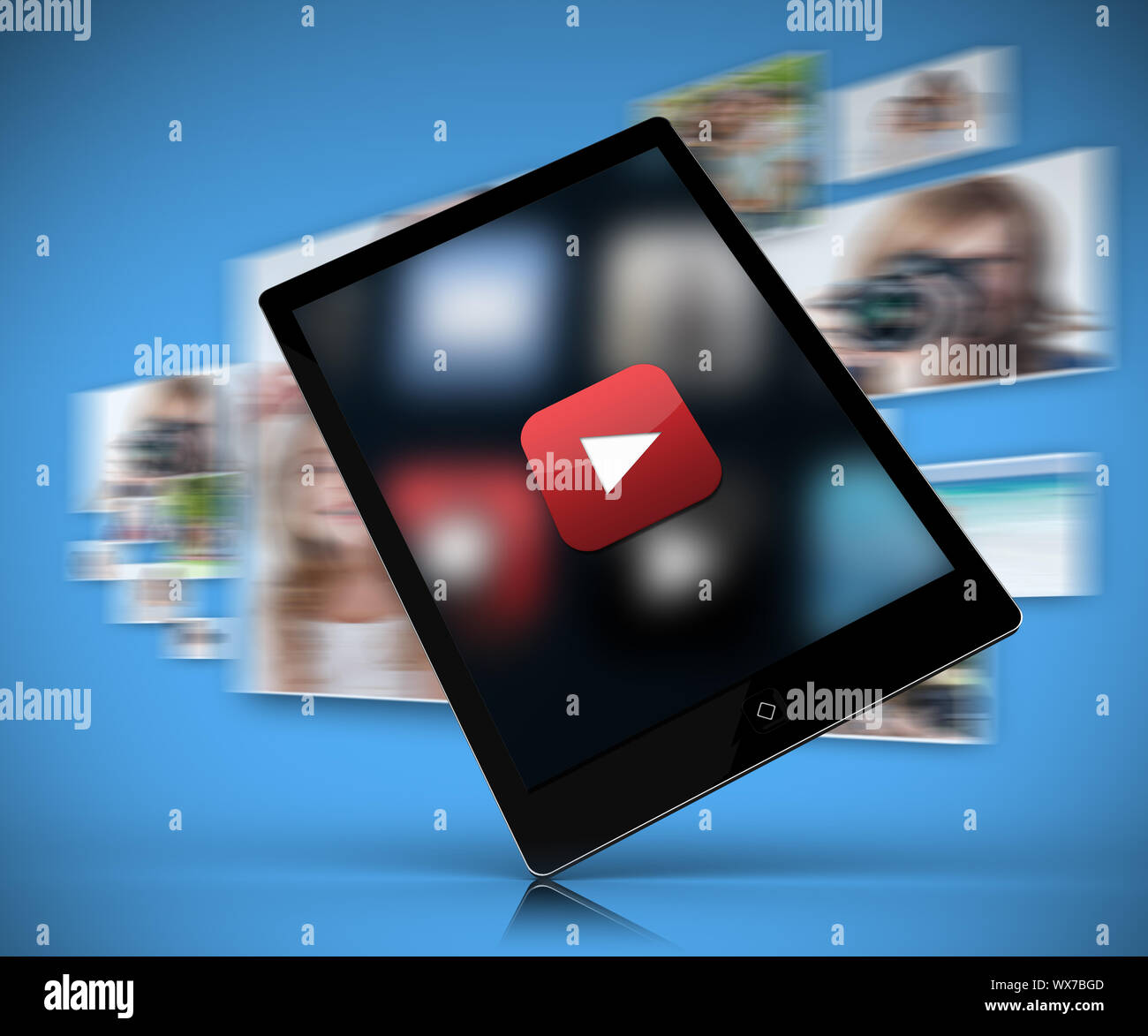 Tablet pc showing play button against blue background with blurred ...