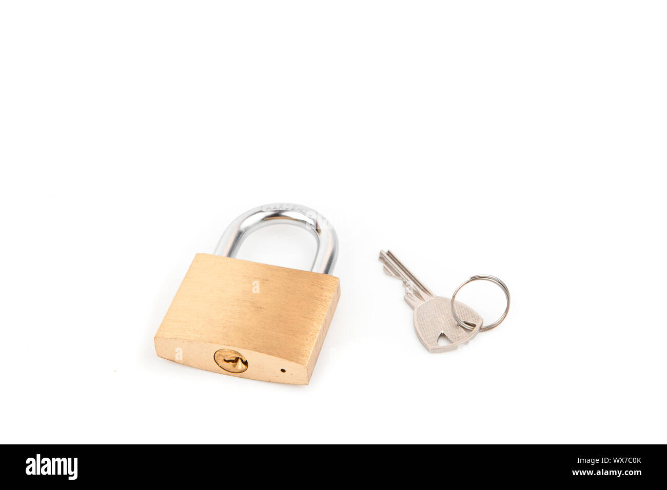 Padlock and key against white background Stock Photo - Alamy