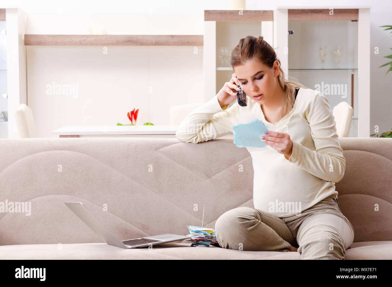 Image showcasing Young pregnant woman in budget planning concept Stock Photo - Alamy