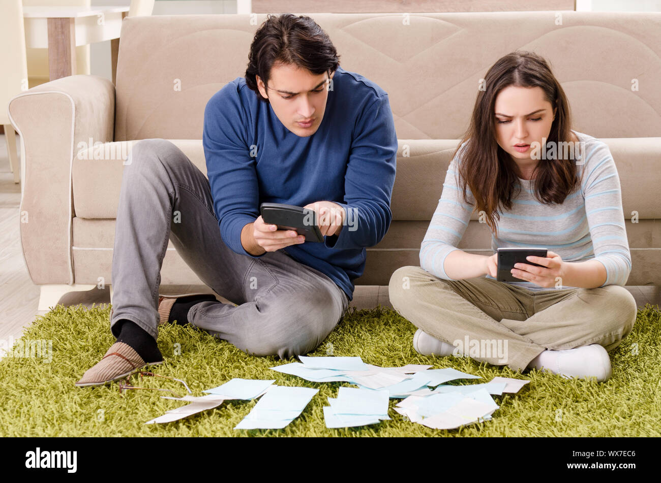 Young couple in budget planning concept Stock Photo - Alamy