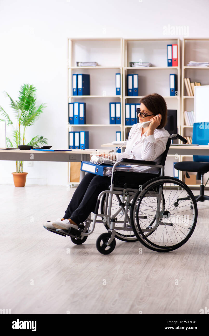 Female employee in wheel-chair at the office Stock Photo - Alamy