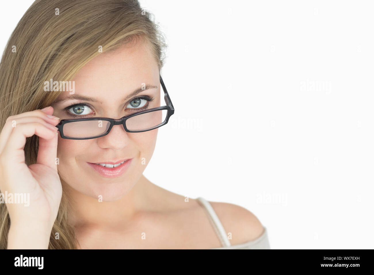 Smiling woman tilting glasses down Stock Photo