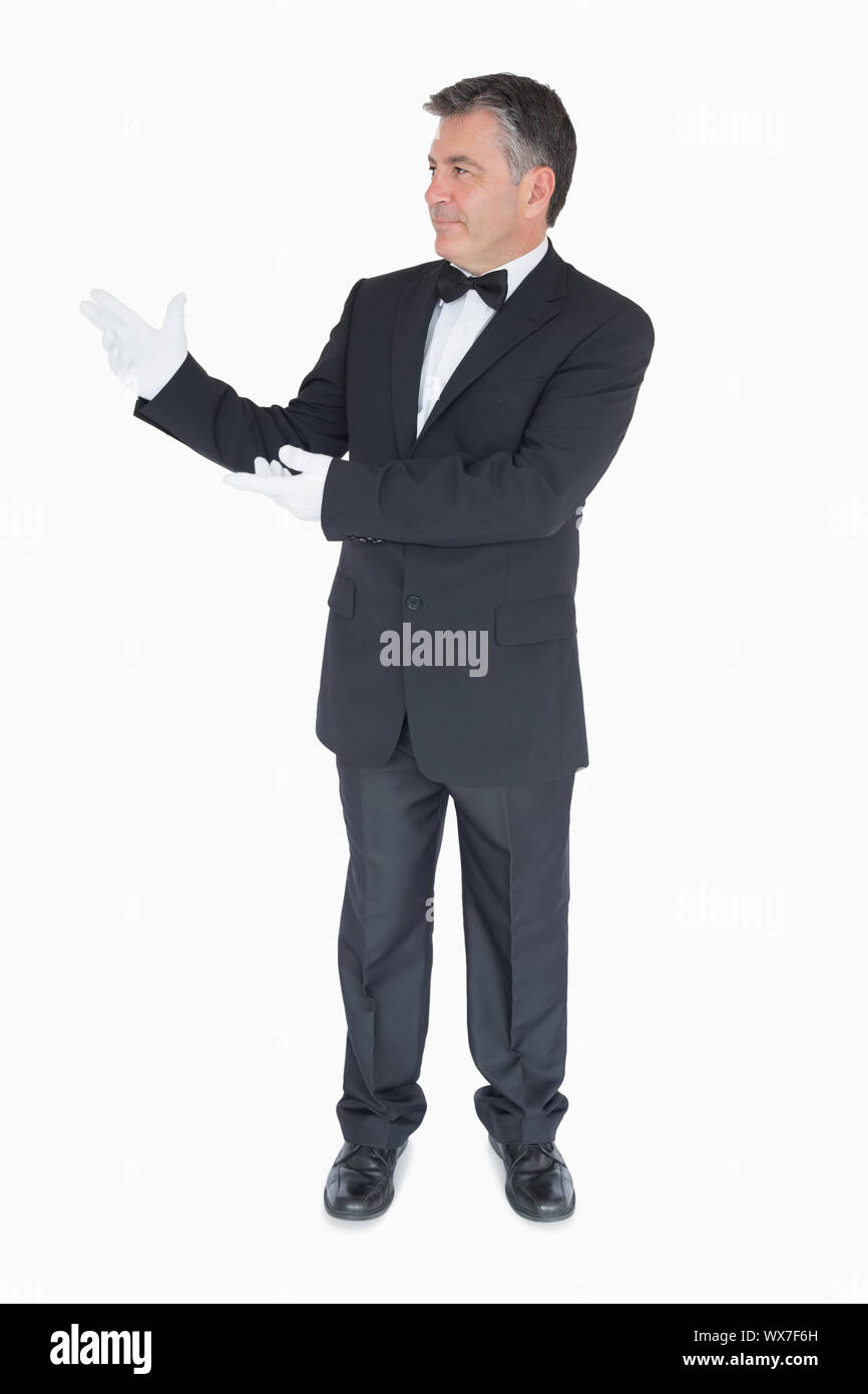 Man in suit showing us something Stock Photo - Alamy