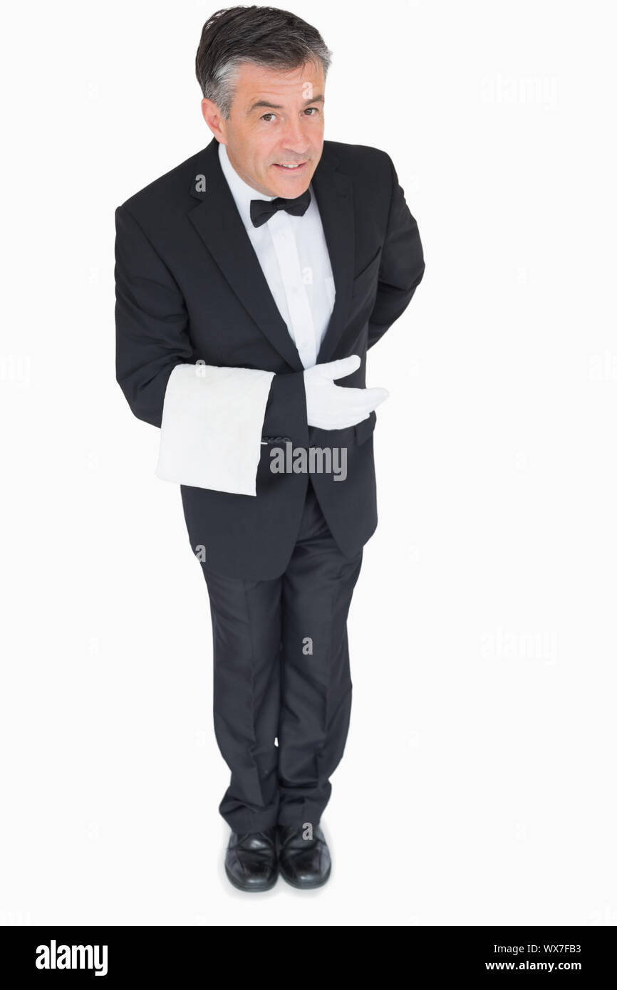 Smiling waiter bowing down with towel on his arm Stock Photo Alamy