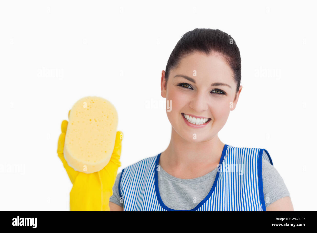 Cleaning woman showing a sponge on white background Stock Photo Alamy