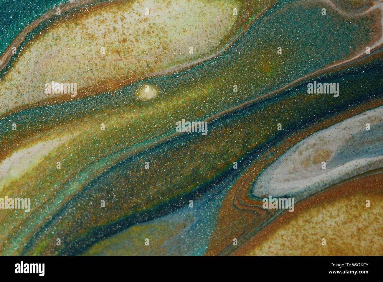 Flowing abstract acrylic painting in glittering teal, darkest blue, white, neon green, and glitter gold with layer upon layer of color for backgrounds. Stock Photo