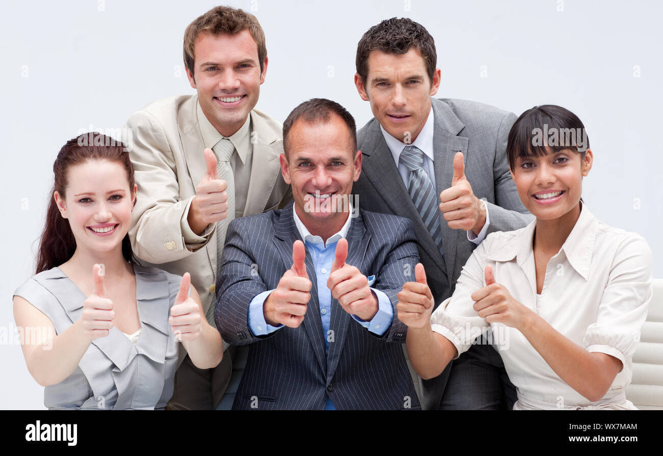 Happy business team with thumbs up in the office Stock Photo - Alamy