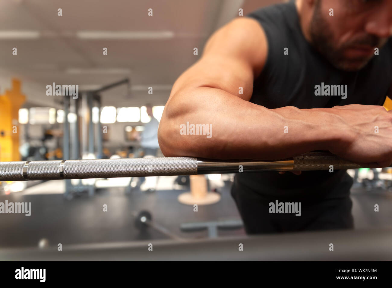 a strong man relaxes in the gym Stock Photo