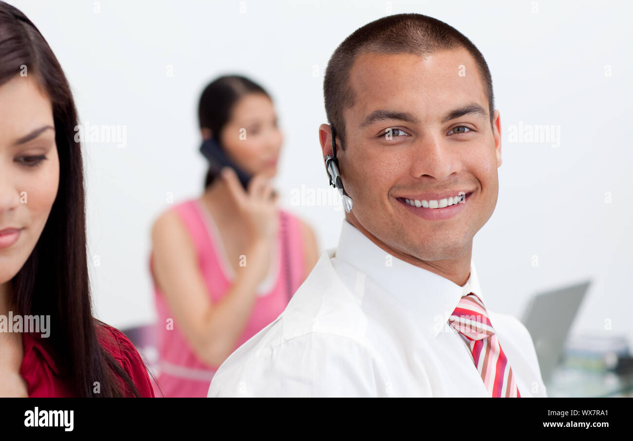 Smiling businessman with headset on at work Stock Photo