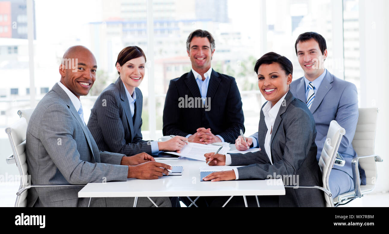 Business group showing ethnic diversity in a meeting smiling at the ...