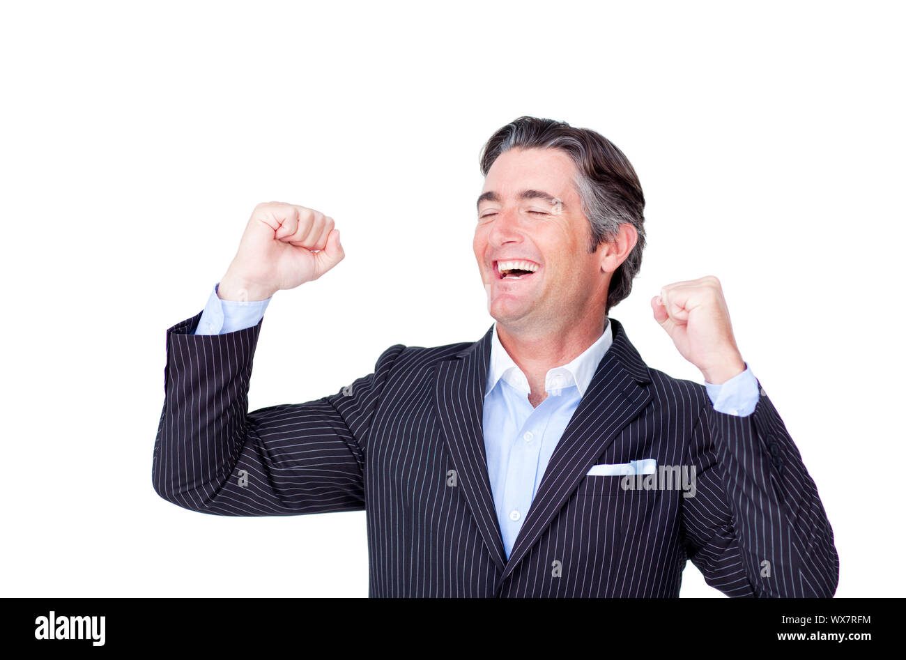 Successful businessman punching the air in celebration against a white ...
