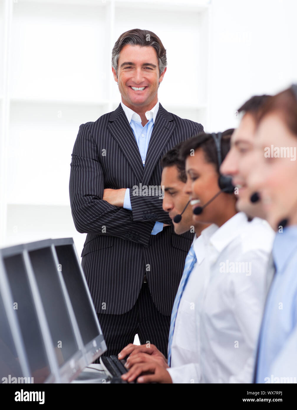 Self-assured businessman presenting a call center in a company Stock Photo