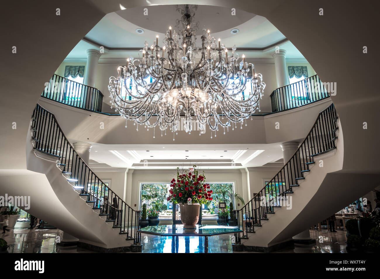 Chandelier hanging over lobby with stair and luxury hall Stock Photo