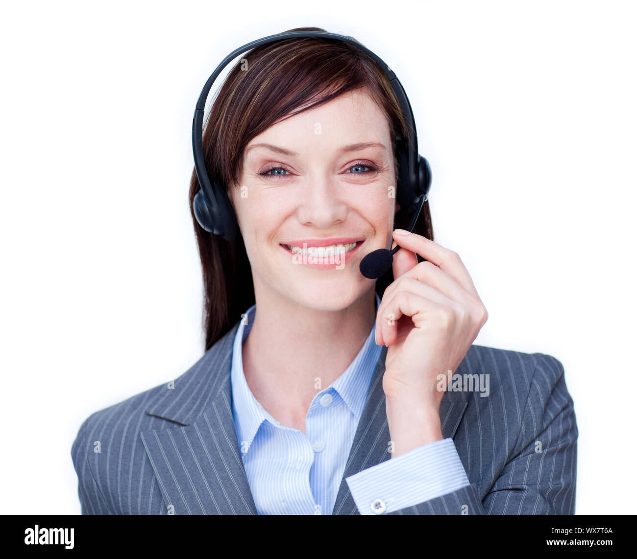 Smiling customer service agent with headset on against a white ...