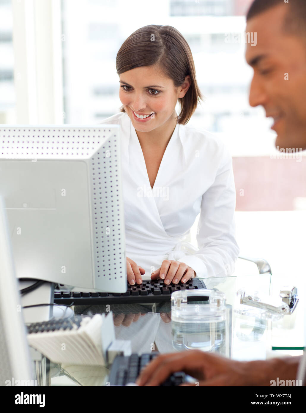 Colleague Computer Two colleagues working at a their computer in the office Stock Photo ...
