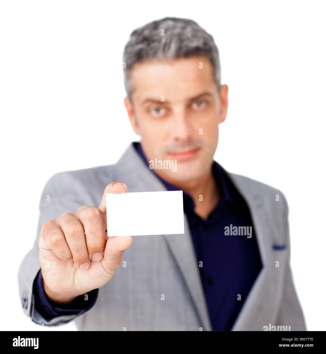 Serious businessman holding a white card against a white background Stock Photo - Alamy