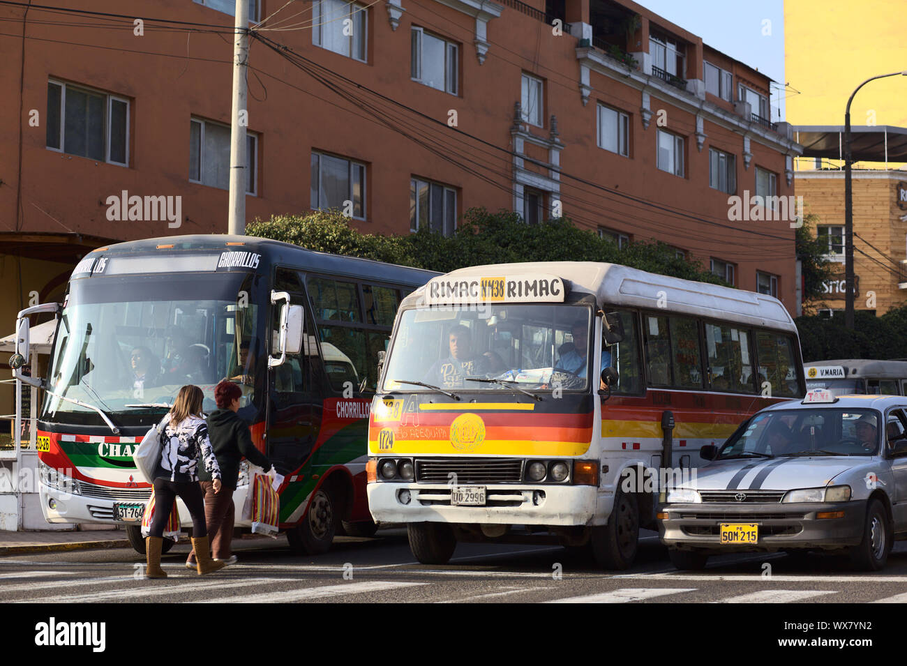 LIMA, PERU - SEPTEMBER 13, 2011: People getting into a bus at red light on Avenida Diagonal on September 13, 2011 in Miraflores, Lima, Peru Stock Photo