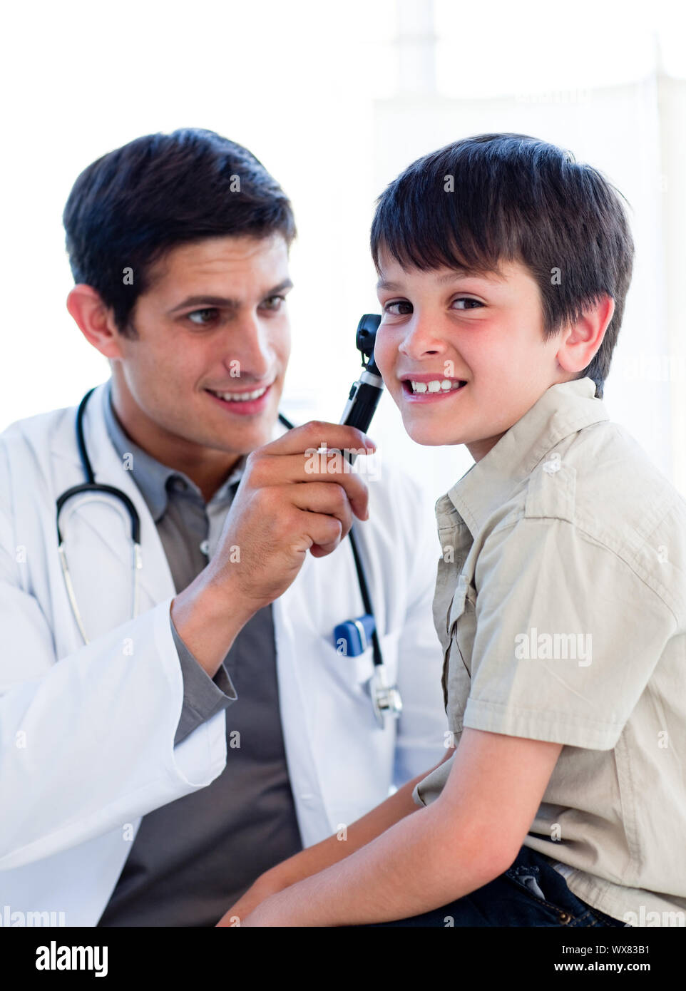 Charming doctor examining little boy's ears at the practice Stock Photo