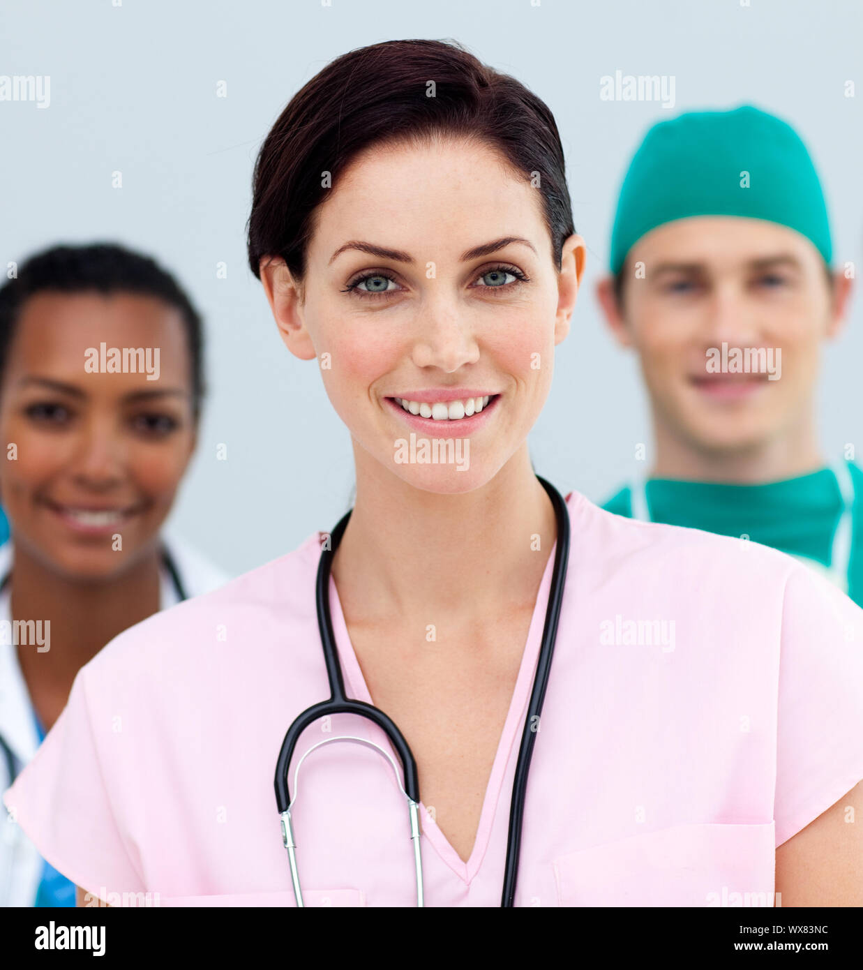Female Doctor standing in Front of her team in the hospital Stock Photo ...
