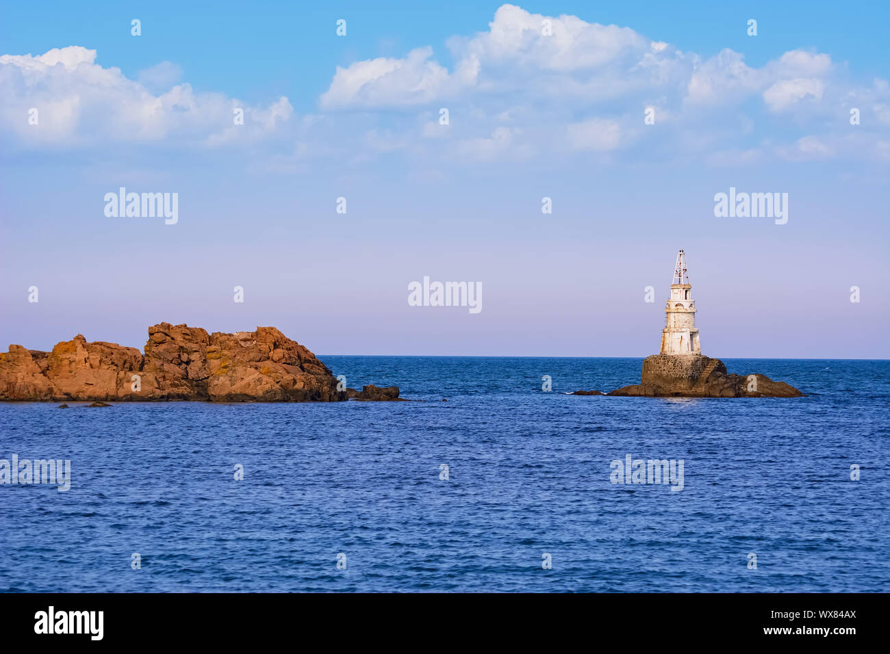 Small Lighthouse in the Sea Stock Photo