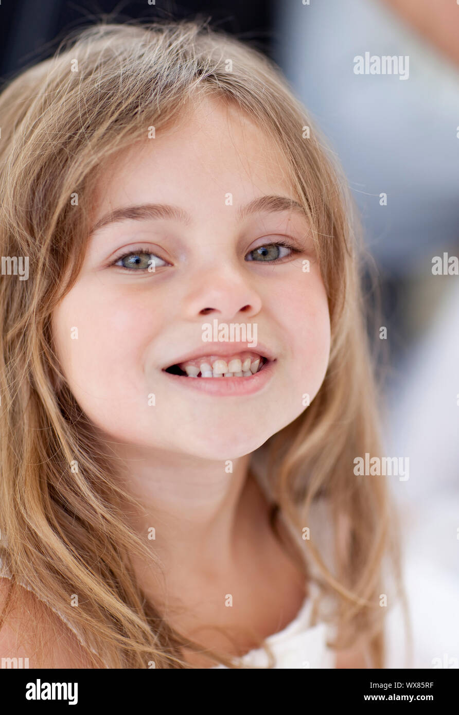 Portrait of a little girl smiling at the camera Stock Photo - Alamy