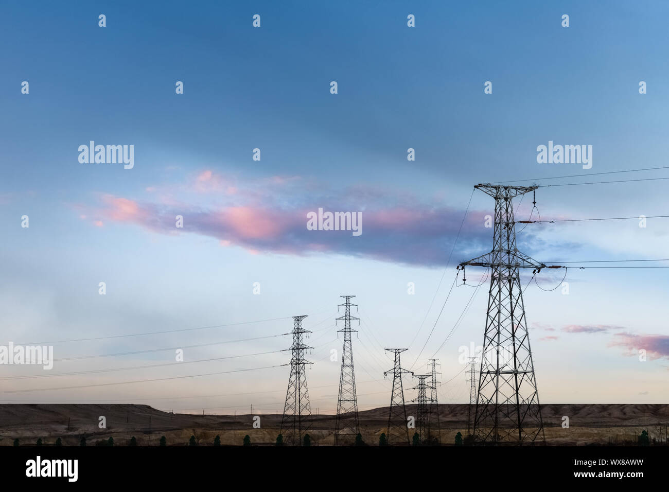 distribution of electric towers at dusk Stock Photo