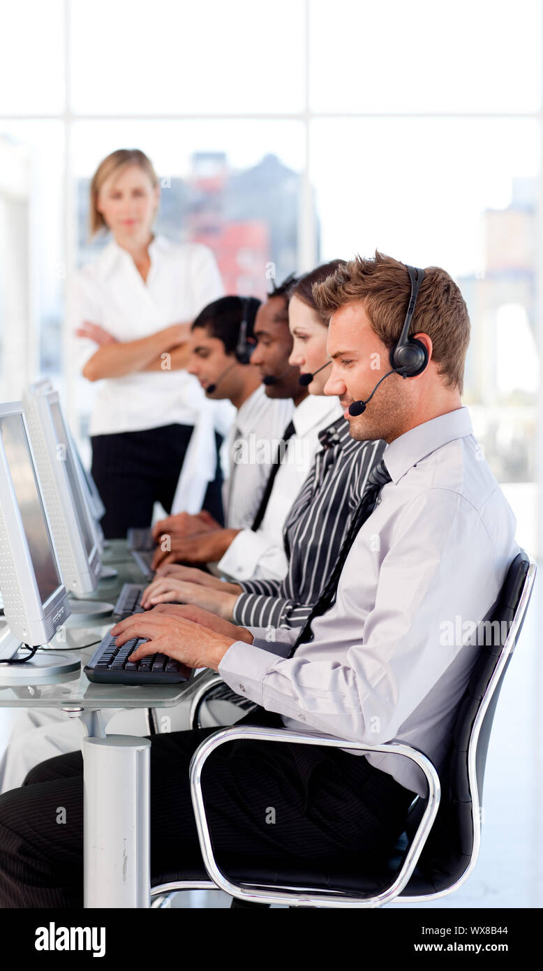 Female leader managing her team in a call center Stock Photo