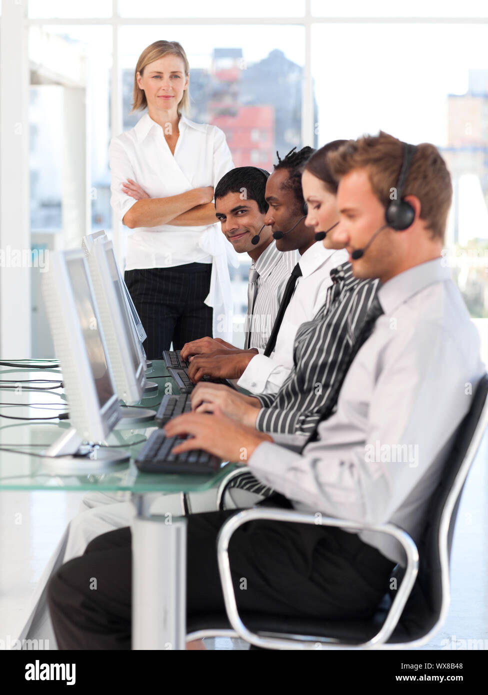 Confident female leader managingher team in a call center Stock Photo