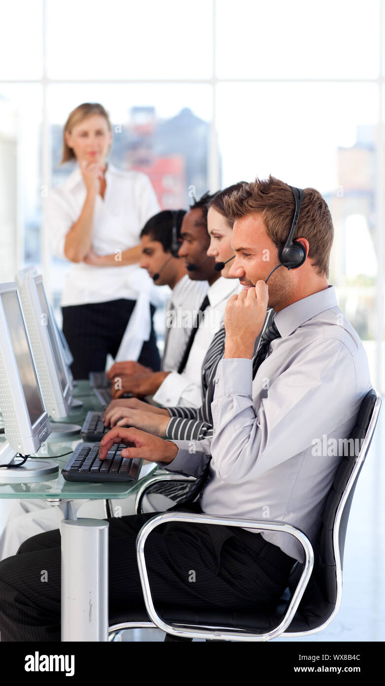 Bright female leader managingher team in a call center Stock Photo