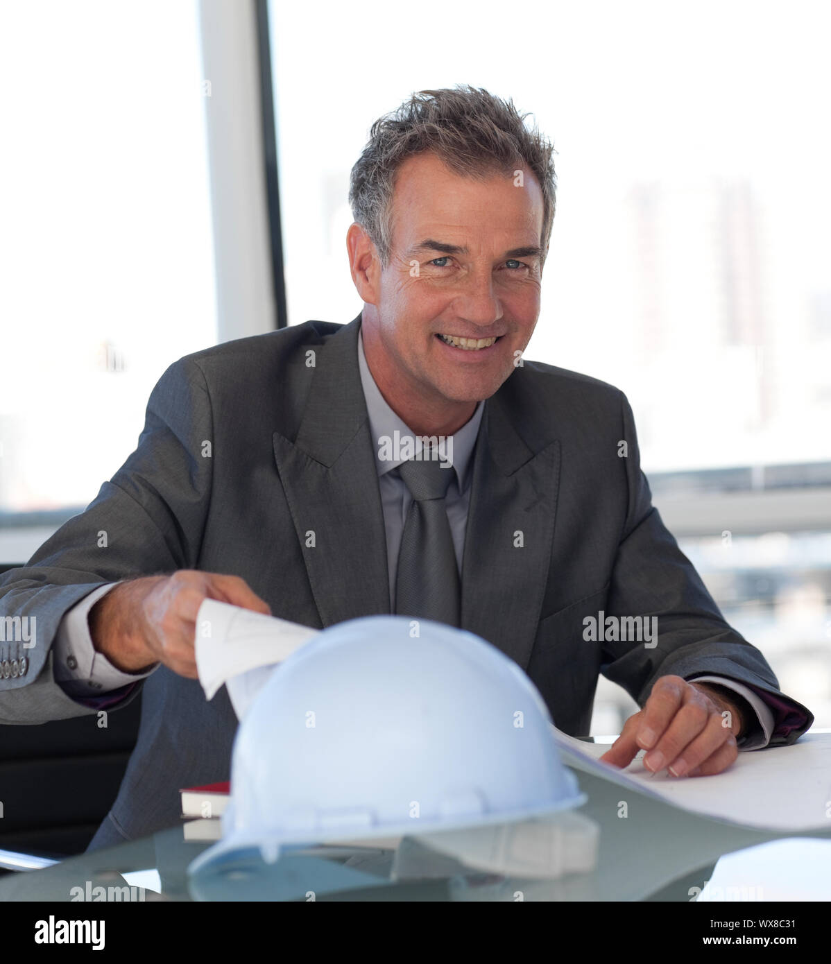 Self-assured Engineer looking at Blueprints Stock Photo - Alamy